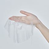 Hand holding an unfolded Mixsoon sheet mask to show its thin fabric and face cutouts