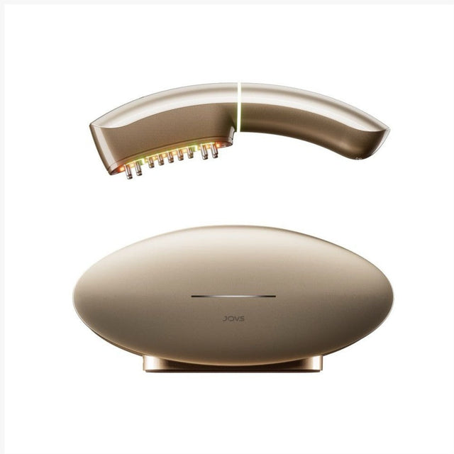 Gold JOVS beauty device with its oval storage base