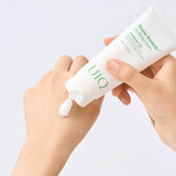 UIQ Biome Remedy Soothing Cream being dispensed onto the back of a hand